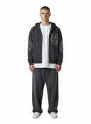 Modelo con sudadera con cremallera gris Eclipse de One Kickz con detalles de pedrería y pantalones a juego