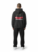 Sudadera con capucha gris oscuro de Nude Project con estampado de cerezas en forma de corazón y logo en la espalda.