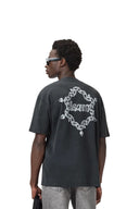 Hombre vistiendo camiseta oversized negra lavada de One Kickz con estampado gráfico de cadenas AllSaints en la espalda