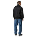 Hombre de espaldas vistiendo chaqueta deportiva negra adidas x Sp5der con detalles de pedrería y jeans azules